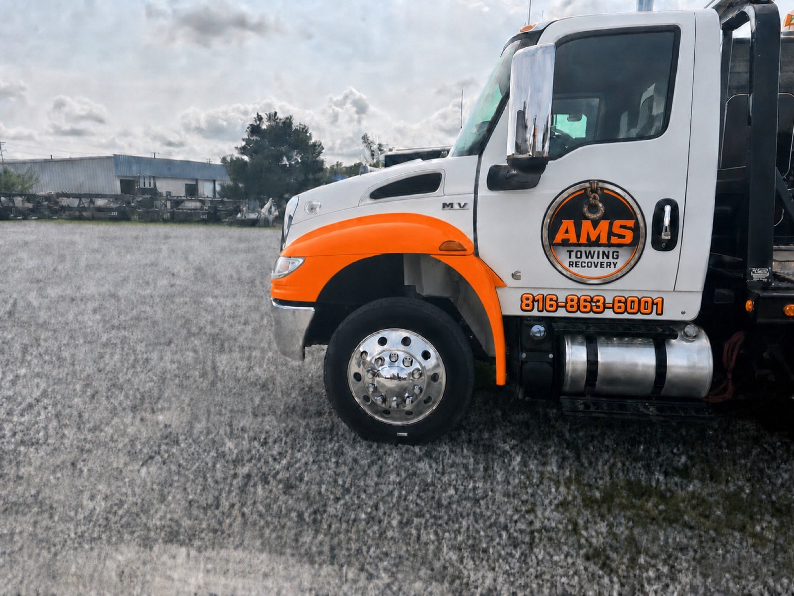 An AMS wrecker with orange fender ready to respond